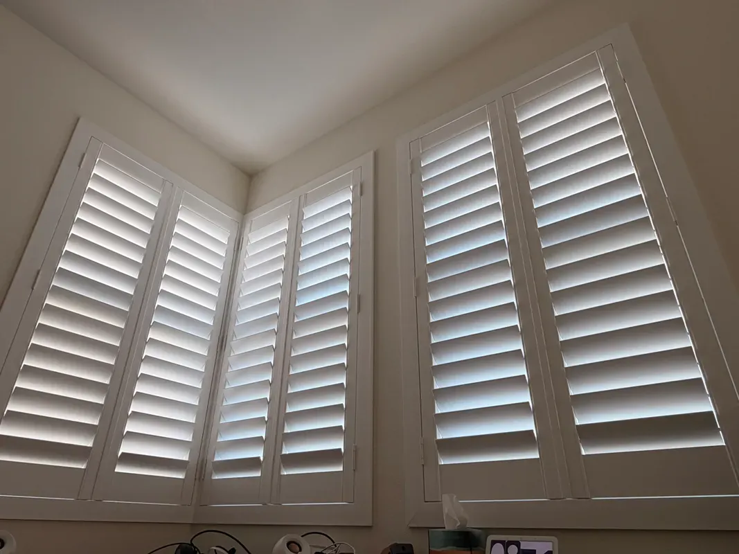 Poly composite plantation shutters professionally installed in Los Angeles area home — clean white louvers